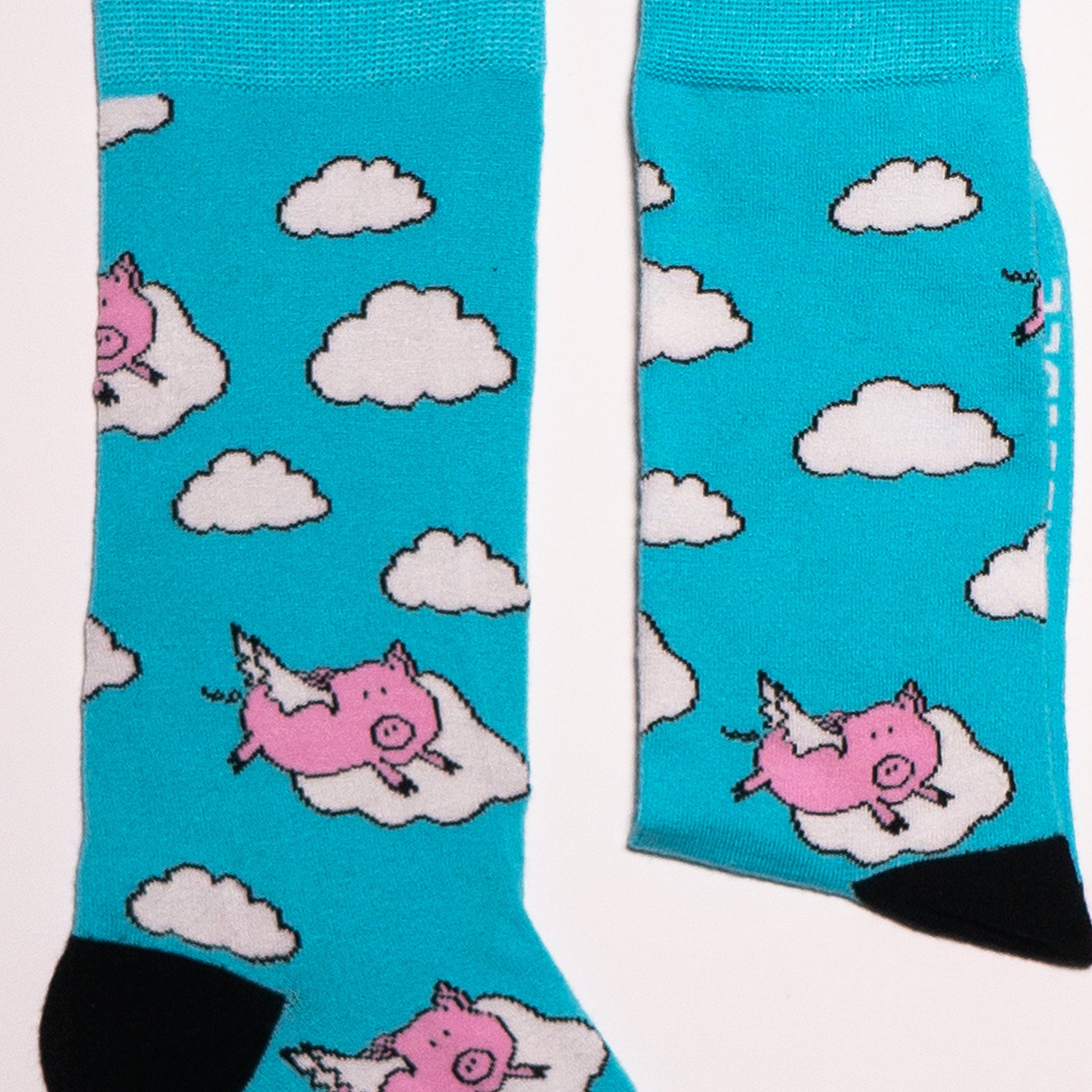 One of our most popular designs. The perfect shade of blue meets our lovable pink pigs - who said these guys could not fly! Soft. Strong. Sustainable. Comfortable. Pigs! On Socks. We know! Madness. Available in US Men’s 4-8 and 8-12