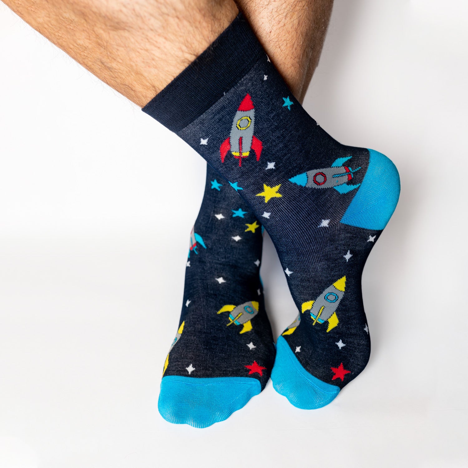 Socks that inspire us to remember those space exploration posters on our bedroom walls and and the days spent dreaming of blasting off to meet aliens from far off planets. Rocket-ships, stars, and, planets. Treat your feet to an out of this world experience. Soft. Strong. Comfortable. Sustainable. Available in US Men’s 4-8 and 8-12