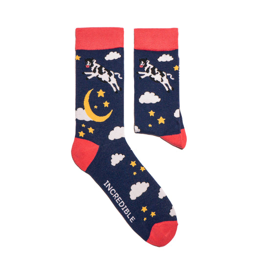 Just like in the nursery rhyme when the cow jumped over the moon. A navy base sets the scene of a fantastical, fun, star-filled night sky. Cows. On Socks. We know!  Available in US Men’s 4-8 and 8-12. Soft. Strong. Sustainable. Comfortable. Incredible Socks. Cow jumping over the moon socks.